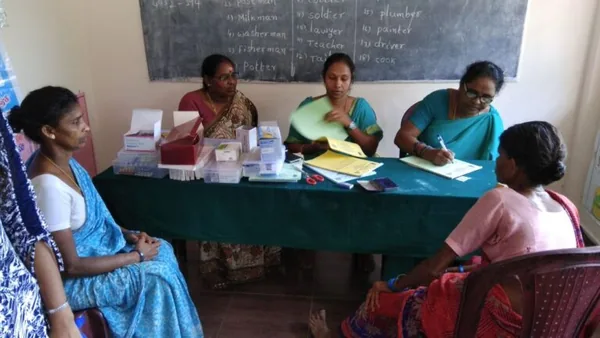 Women seated together at a table during a group discussion.