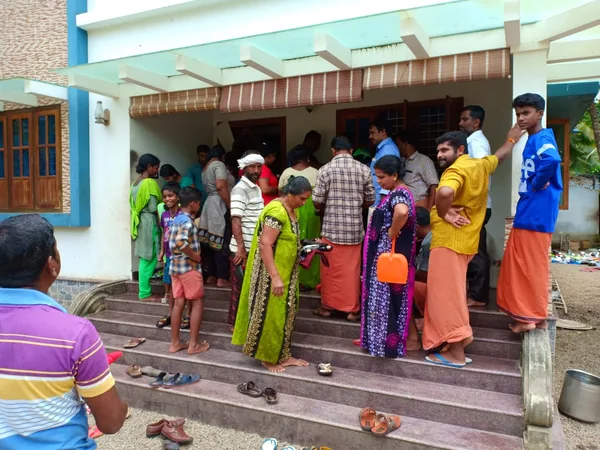 Adults and children gathered outside a building.